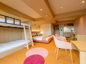 a bedroom with two bunk beds and a kitchen at RESI STAY Nishijin in Kyoto