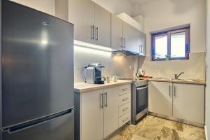 uma cozinha com um frigorífico de aço inoxidável em Maria House em Lithakia