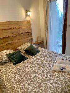 1 dormitorio con 1 cama con 2 almohadas en Le Café Crème jardin parking, en Le Chambon-sur-Lignon
