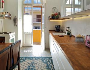 a kitchen with a counter and a clock on the wall at Romantic rooms with stunning sea view in Rhodes Town