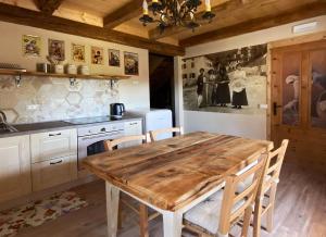 een keuken met een houten tafel en stoelen. bij Casa del Piol Fattoria dei fiori in Sospirolo