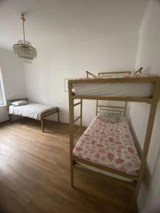 a small room with a bunk bed and a bench at Rooms Miklošičeva in Ljubljana