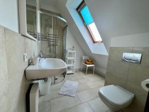 a bathroom with a sink and a toilet at Bursztynowa 16 Hel in Hel +52 photos