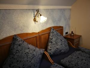 a bedroom with a bed with two pillows on it at Ferien in der alten Scheune in Kurort Altenberg