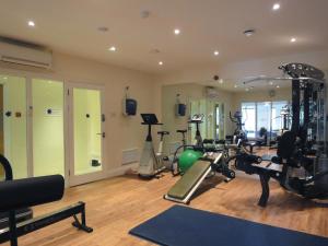 a gym with several treadmills and exercise bikes at 23 Burgh Island Causeway in Bigbury on Sea
