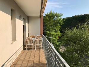a balcony with two chairs and a table on it at Condominio Aquila in Bibione