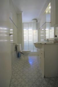 a white bathroom with a toilet and a sink at CasaTuris Playa Postiguet A113 in Alicante