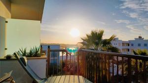 a balcony with a view of the sunset at Blue House Mallorca in Ses Salines
