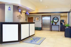 an office lobby with a reception desk and a door at Microtel Inn & Suites by Wyndham Waynesburg in Waynesburg