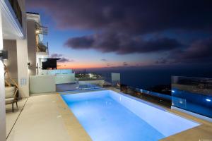 a swimming pool on the roof of a house at Inorato - Luxury Villa with Private Swimming Pool in Kalamitsi