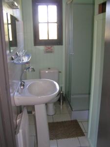 a bathroom with a sink and a toilet and a shower at Domaine de Vaulatour. in Payzac
