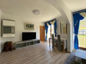 a living room with a flat screen tv and a table at Holiday Apartment mit Moselblick im Moselhaus in Cochem