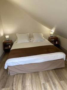a bedroom with a large bed with two night stands at Les Afforêts Le Loft in La Roche-sur-Foron