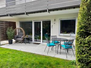 a patio with a table and chairs on a patio at Ammersee Apartment Schondorf in Schondorf am Ammersee