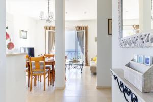 a dining room and living room with a table and chairs at Sea View Apartment with Private Secure Parking 1 in Villefranche-sur-Mer