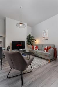 a living room with a couch and a chair at Host Liverpool - Anfield Stadium Home, Cozy House for Family in Liverpool