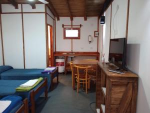 a room with two beds and a table and a television at Tierra Yacampis264 in Usno