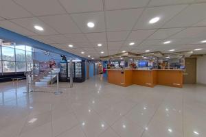 a lobby of a store with a staircase in it at Rodeway Inn & Suites Fort Lauderdale Airport & Cruise Port in Fort Lauderdale