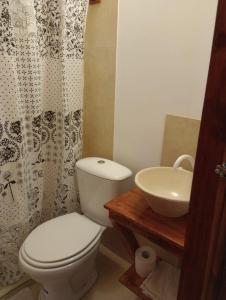 a bathroom with a toilet and a sink at Tierra Yacampis264 in Usno