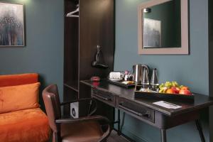 a hotel room with a desk with a tray of fruit on it at Hotel Balmoral in Newcastle upon Tyne