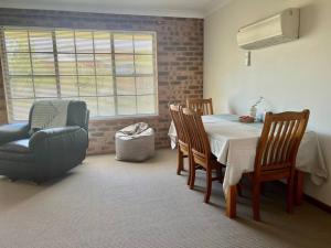 a dining room with a table and a chair at Stay on Lachlan in Cowra