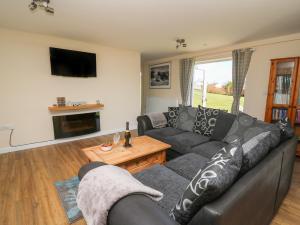 a living room with a couch and a table at Brynteg Cottage in Llanfyrnach