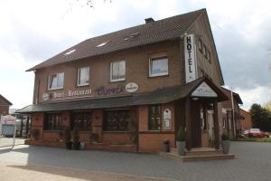 a building with a sign on top of it at Hotel-Restaurant Olympia in Selm