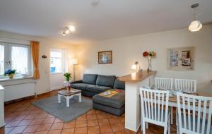 a living room with a couch and a table at Godewind ebenerdig in Westerland
