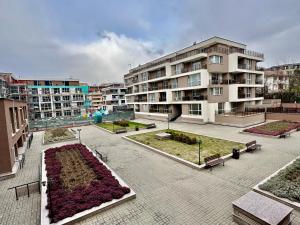 a large courtyard with benches and a building at Allegro Home, Apartment by LMG in Sofia