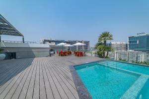 a swimming pool on the roof of a building at Hotel Deccan Serai Grande, Gachibowli, Hyderabad in Hyderabad