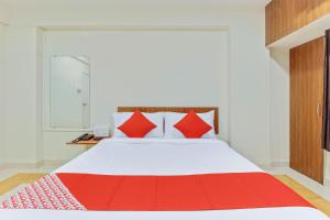 Un dormitorio con una cama con almohadas rojas. en Chaitanya Near Fun Time Multiplex, en Yerandwane