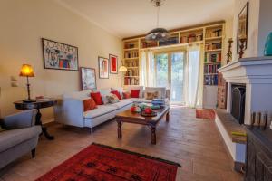 Secluded villa في كونتوكالي: غرفة معيشة مع أريكة ومدفأة