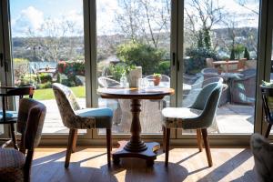 a table and chairs in front of a window at Victoria Hotel by Chef & Brewer Collection in Menai Bridge