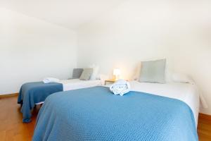 two beds in a room with blue and white at RNET - Casa 4 - Vista Mar Almadrava Roses in Roses +45 photos