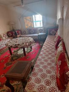 Villa kaoutar في مرتيل: غرفة معيشة مع أريكة وطاولة