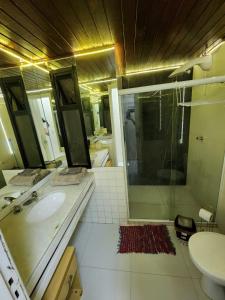a bathroom with a sink and a shower at Apartamento único na praia do Farol de Itapuã in Salvador