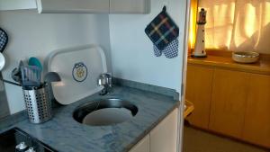 a kitchen with a sink with a blue counter top at Boat Sirio in San Miguel de Abona