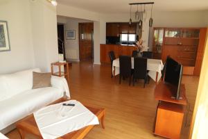 a living room with a couch and a table with a tv at Evimerou Villa in Kos