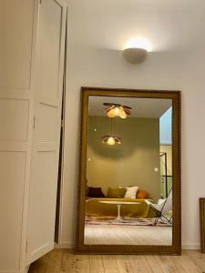 a mirror in a room with a living room with a couch at L’appartement 39 in Lons-le-Saunier