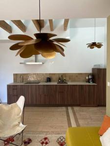 a kitchen with two ceiling fans and a table at L’appartement 39 in Lons-le-Saunier