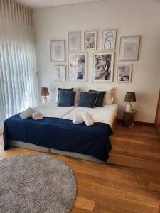 a bedroom with a large white bed with blue pillows at Villa Mar in Troia