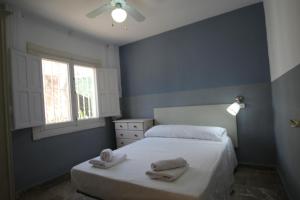 a bedroom with a bed with towels on it at Casa La Noria by Rental Olé in Murcia