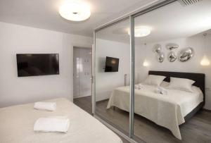 a bedroom with two beds and a glass wall at Sea view penthouse in Vari in Vari