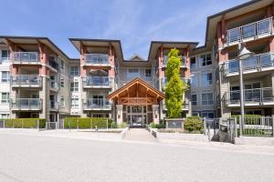 a large apartment building with a pavilion in front of it at Downtown Osprey Condo at Waterscapes in Kelowna