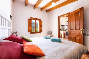 a bedroom with a large bed with pillows on it at Villa Florida in Fornalutx +20 photos