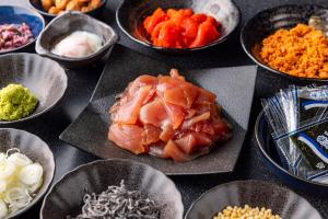 a table topped with bowls of food with carrots and other ingredients at Tokyu Stay Takanawa Shinagawa Area in Tokyo