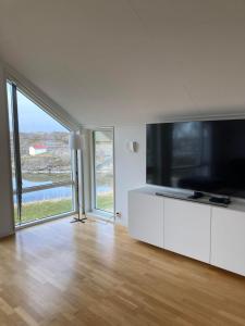 a living room with a large flat screen tv at Luxury Villa - Villa Seaside in Gothenburg