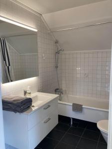 a bathroom with a sink and a tub and a mirror at Luxury Villa - Villa Seaside in Gothenburg