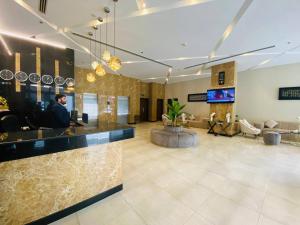 a man sitting at a bar in a hotel lobby at HAVEN TOWER in Juffair