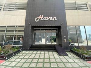 a building with the entrance to a larger sign on it at HAVEN TOWER in Juffair